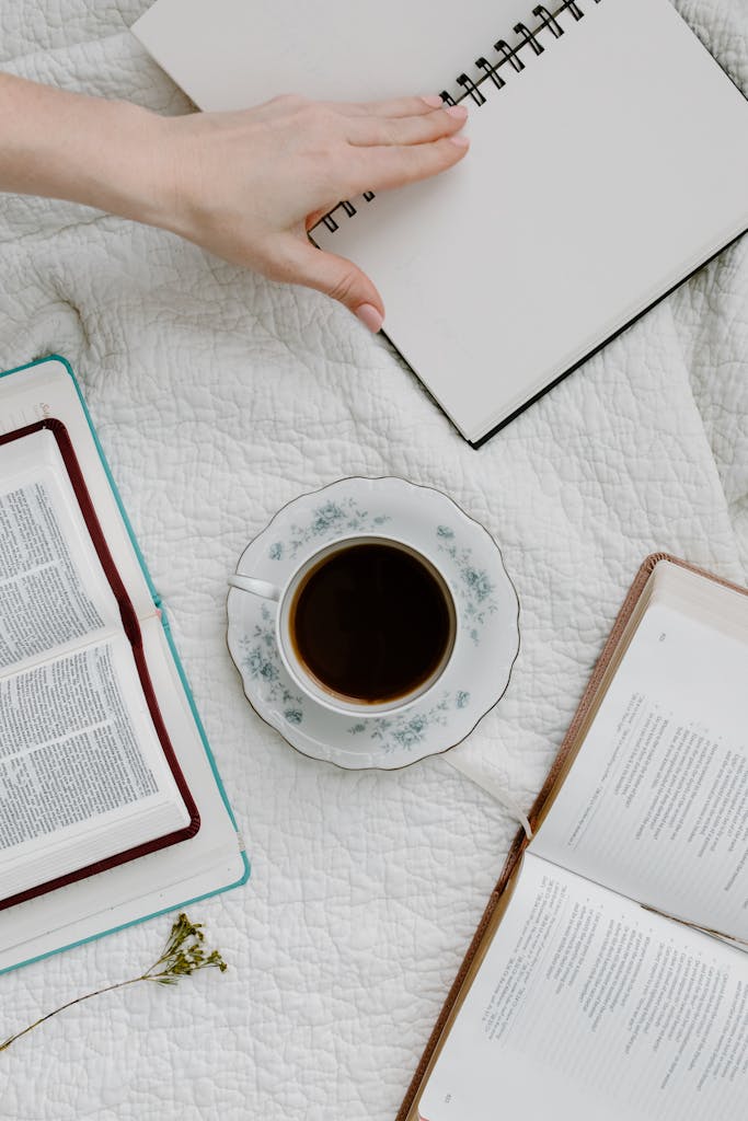 Open Bible and coffee on bed, perfect for a peaceful study session.